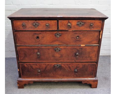 An early 18th century featherbanded walnut chest with two short and three long graduated drawers on bracket feet, 99cm wide x