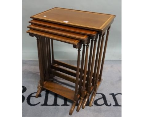A Regency style mahogany nest of four tables on ring turned supports, the largest 57cm wide x 69cm high