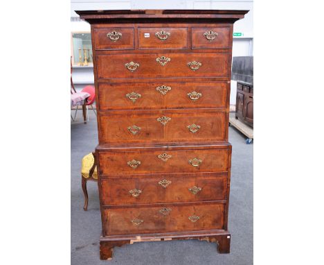 A George III feather and cross-banded walnut chest on chest with three short over six long graduated drawers, on bracket feet