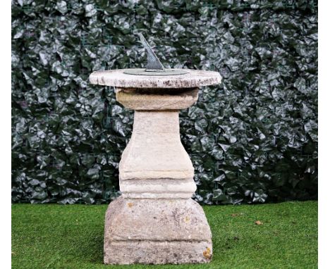 A cast bronzed sundial on a stone square baluster column, 80cm high