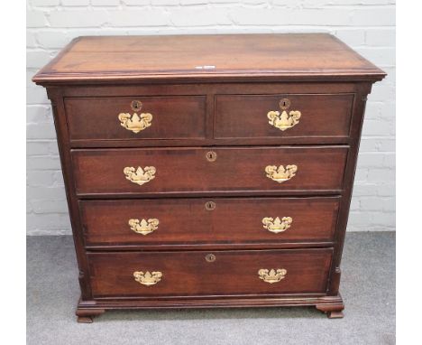 A mid-18th century mahogany banded oak chest of two short and two long graduated drawers, flanked by turned corners, on ogee 