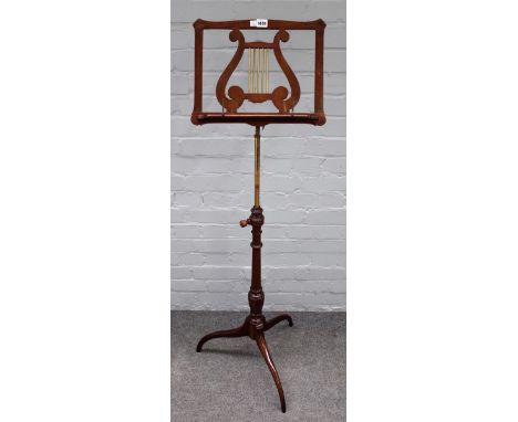 A late 19th century mahogany height adjustable music stand, with lyre decoration and tripod base 40cm wide. 