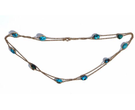 A gold and turquosie matrix long chain, the oval link chain spaced with collet set turquoise matrix at intervals, on a boltri