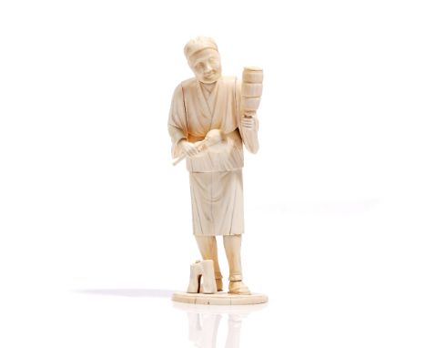 A Japanese ivory sectional okimono of a musician, Meiji period, carved standing with a gourd vase and stick in his right hand