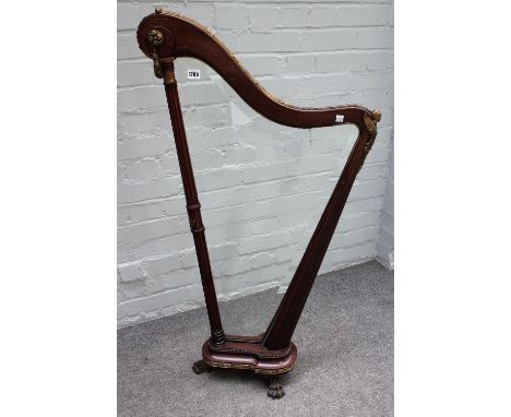 A 19th century gilt metal mounted mahogany firescreen, modelled as a harp on paw feet, 60cm wide x 114cm high.