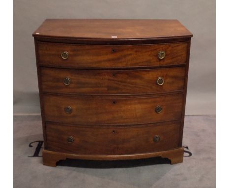 A late George III mahogany bowfront chest of four long graduated drawers on bracket feet, 101cm wide x 97cm high. 