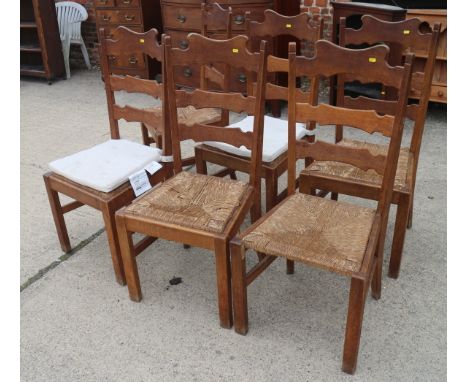 A set of six Belgian oak ladder back dining chairs with rush envelope seats, on square supports 