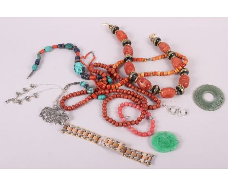 A collection of coral bead necklaces, a carved jade pendant and other jewellery 