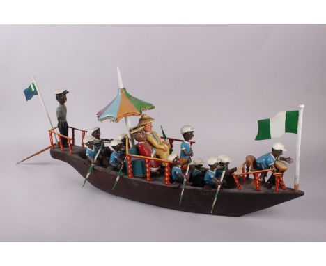 A vintage wooden model boat with figures 