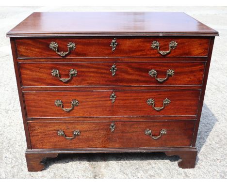 A George III mahogany chest of four long graduated drawers with gilt brass scroll handles, on bracket feet, 36" wide x 21" de