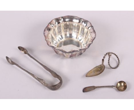 A silver sugar bowl, a silver mustard spoon, a pair of silver tongs and a white metal leaf-shaped caddy spoon, 6.8oz troy app