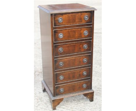 A walnut and banded bedside chest of six long drawers, on bracket feet, 15 1/2" wide x 15" deep x 33" high 