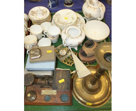 A 19th century gilt decorated part teaset, a set of postal scales and weights, a brass candlestick, a brass trivet, a brass h