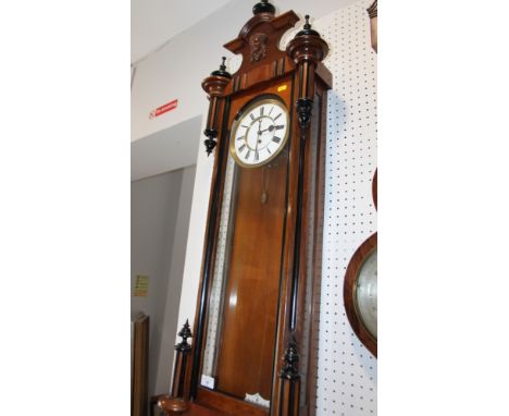 A 19th century walnut cased Vienna style wall clock with white enamel dial, 52" high 