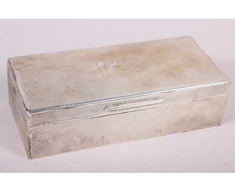 A silver cigarette box with engine turned decoration, 7 1/2" wide 