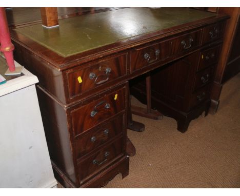 A mahogany double pedestal desk with green tooled leather top, fitted nine drawers, on bracket feet, 48" wide x 24" deep x 31