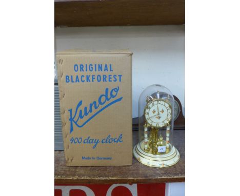 A Kundo cream and gilt anniversary clock, with original box