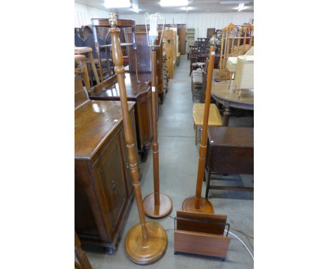 Two teak standard lamps, beech standard lamp and a teak magazine rack