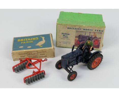 Britains - A boxed Fordson Major Tractor with rubber tyres and farmer figure # 128F with a boxed Disc Harrow # 135F. The mode