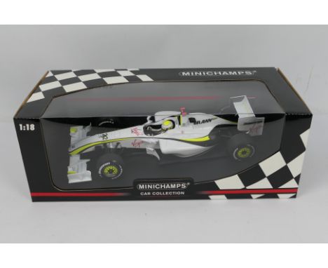 Minichamps - A boxed 2009 Jensen Button Brawn GP BGP 001 in 1:18 scale # 090022. The model appears in Mint condition in a Nea