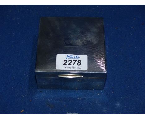 A square Silver cigarette Box, Birmingham 1955 by W.N.S. Ltd., having engine turned top with monogram JHL.