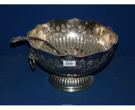 A large silver plated Punch Bowl and a ladle, decorated with roses.