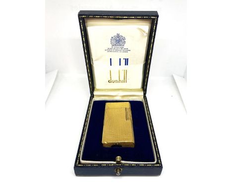 A Vintage Dunhill ‘70’ gold plated gas lighter, with engine turned decoration, in a fitted case, includes manual