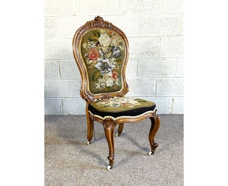 A Victorian walnut nursing chair, circa 1860, with spoon back and tapestry and beadwork upholstered back and seat, decorated 