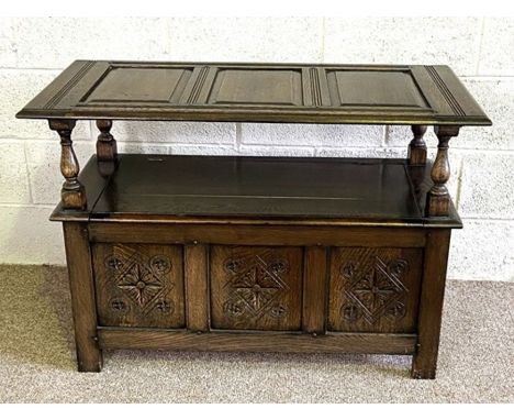 A vintage 17th century style oak monks bench, 20th century, with panelled hinged top, 75cm high, 106cm wide