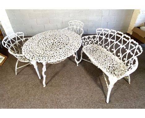 A vintage garden bench, table and two matching armchairs, Victorian style, with scrolled trellis backs and scroll legs untitl