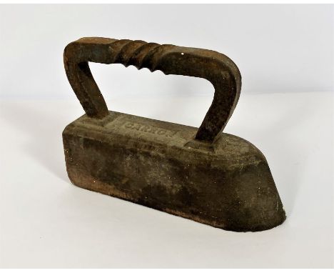 A Carron cast and wrought iron 12 kilogram weighted iron, circa 1900; together with a vintage oil lamp and a 1930’s mantel cl