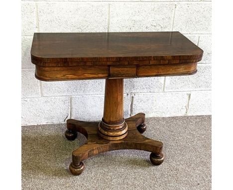 An attractive William IV rosewood card table, circa 1830, with a fold-over rotating top, baize lined card surface, set on a p