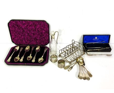 A small group of assorted silver, including a set of six cased tea spoons, a silver topped cruet bottle, two napkin rings and