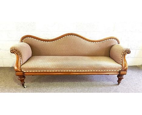 A Victorian double ended walnut day bed or settee, circa 1860, with a serpentine moulded back, padded back and seats, with sc