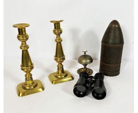 A vintage replica WWI tin plate shell biscuit tin; also a pair of 19th century brass ejector candlesticks; a pair of binocula