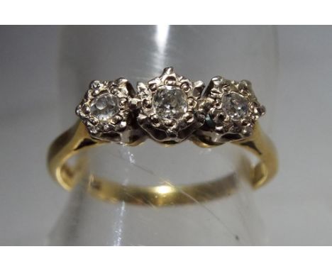 A lady's 18 carat yellow gold ring set with three old cut diamonds, total diamonds approx 15 pt, size O, approx weight 3.15 g