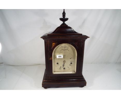 An early 20th century Westminster chiming table clock, dark stained mahogany case, surmounted by a finial, arched silvered di