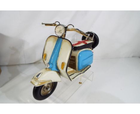 A hand painted metal model depicting a Lambretta scooter contained in original box Est £20 - £30