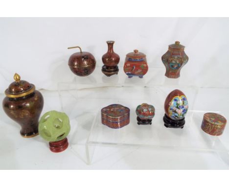 A good collection of Cloisonné enamelled items to include trinket boxes, vase lidded jars and similar and a carved stone puzz