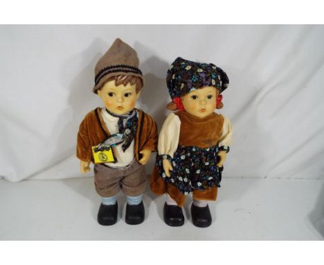Hummel - two Hummel ceramic dolls depicting little girl and little boy with authentic clothing, makers mark to the back of th
