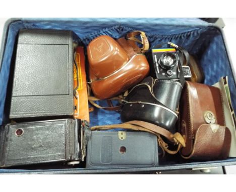 Photography - a vintage Antler suitcase containing a quantity of vintage photographic equipment to include Polaroid camera, K
