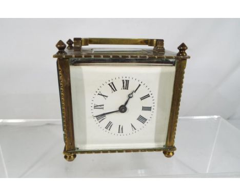 An early 20th century carriage clock, brass and glass cased, white enamel dial in good codition, blued steel hands, platform 
