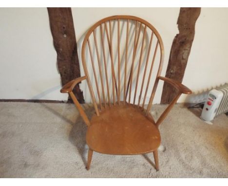 Ercol - a mid 20th century light beech and elm Ercol stick-back fireside armchair
