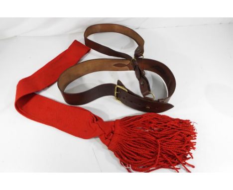 An officer's belt with shoulder strap and red sash Estimate £25 - £35