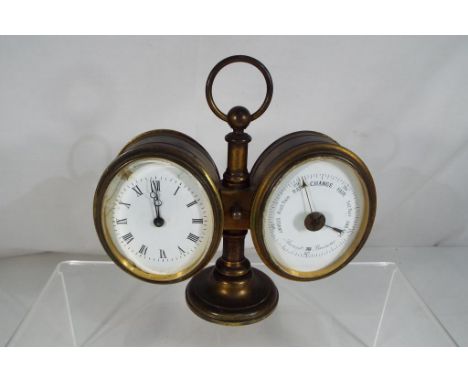 An early 20th century desk compendium of clock and barometer, both with oval white enamel dials, cast-brass cases mounted on 