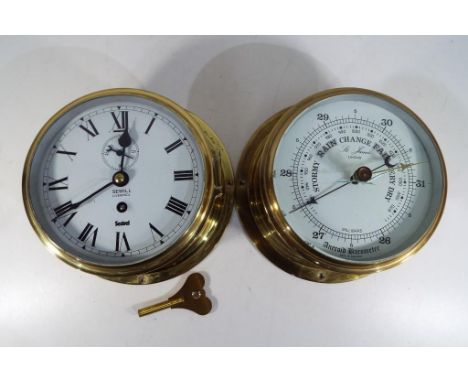 A brass ships bulkhead clock with white dial marked Sewill Liverpool Sestrel, Roman numerals with subsidiary second dial and 