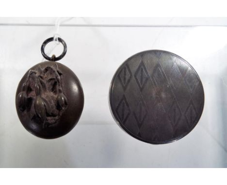 A George V silver hallmarked lady's powder compact Birmingham assay 1932 along with a hair locket (2)