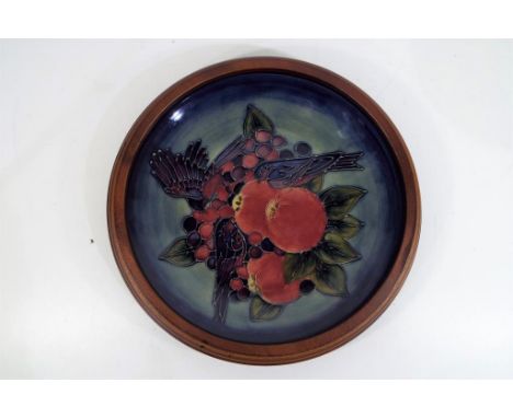 Moorcroft - a large ceramic Moorcroft plaque with wooden surround, approx 29cm (d), Est £70 - £90