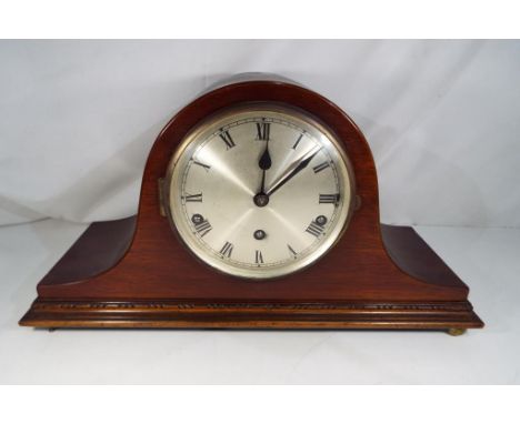 A mahogany cased mantel clock with pendulum