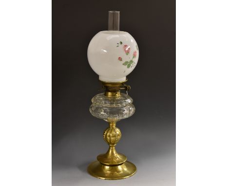 A Victorian glass and brass oil lamp, Hinkes and Co. patent, milk glass shade, facetted clear glass reservoir, bulbous column